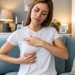 The Role of a Breast Surgical Oncologist in Early Detection and Prevention 1 woman palpating her breast